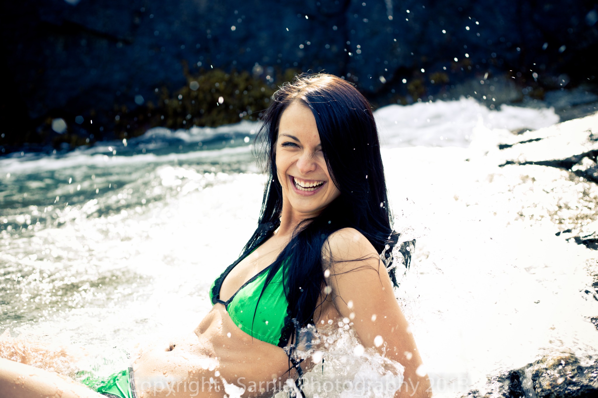 Joyful coastal swimsuit portrait in moving water